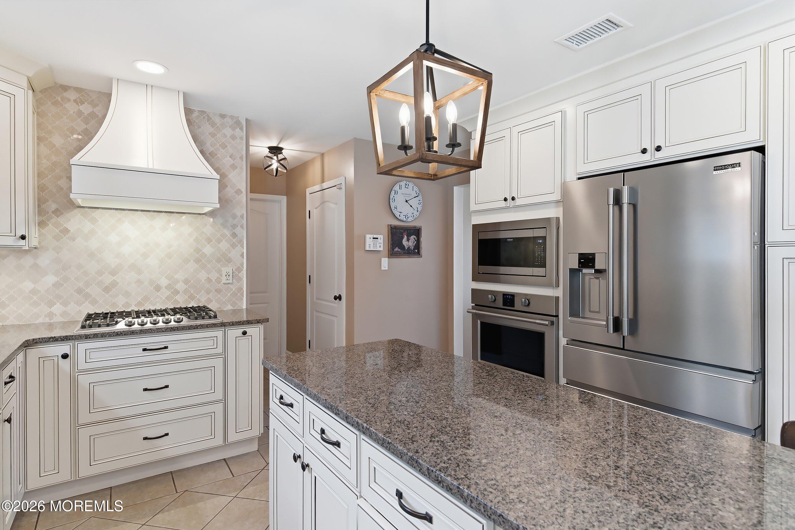 23 Paulette Lane Howell, NJ 07731 - Photo 19 of 35 a kitchen with stainless steel appliances a refrigerator stove and microwave