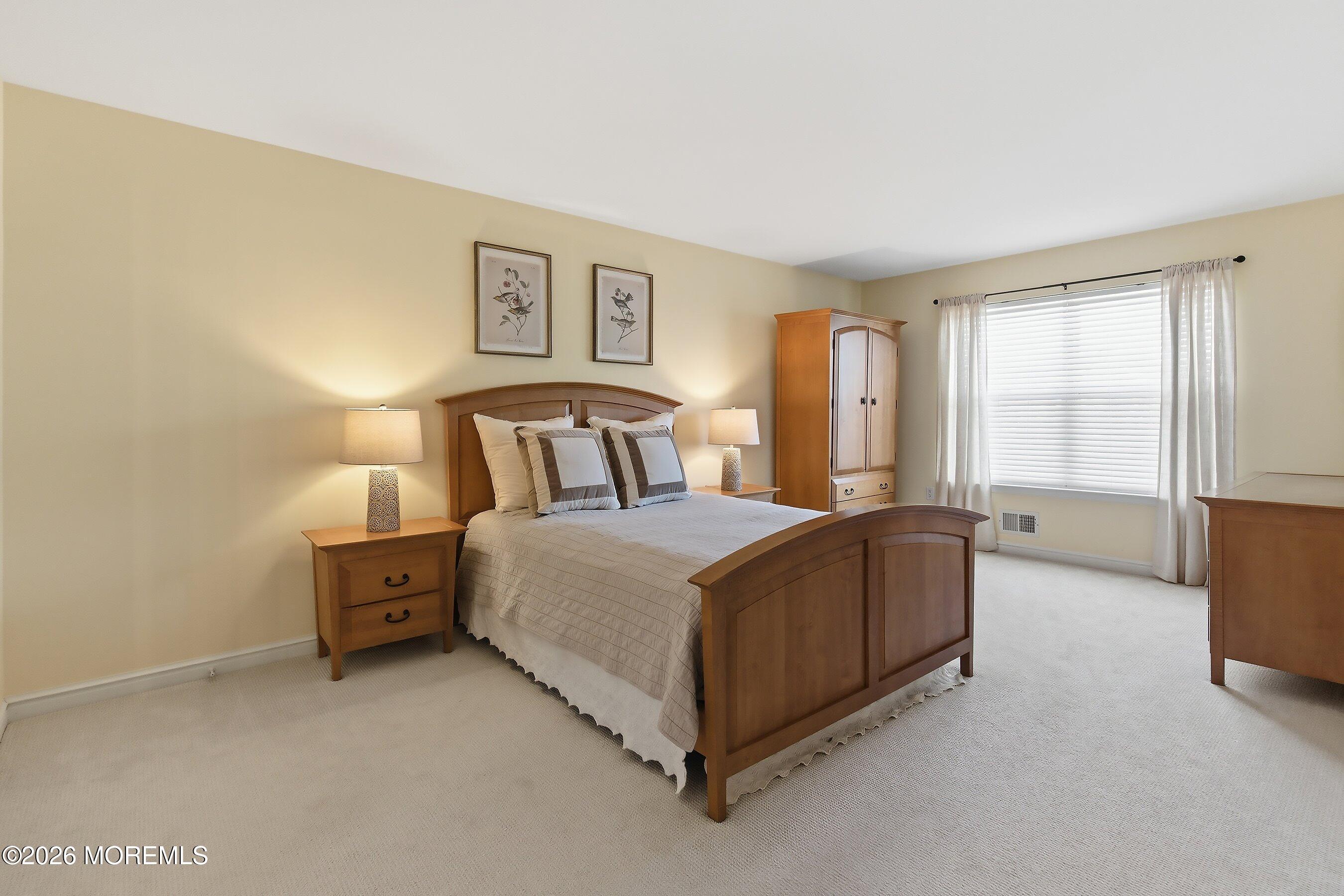 23 Paulette Lane Howell, NJ 07731 - Photo 24 of 35 a bedroom with a bed couch and window
