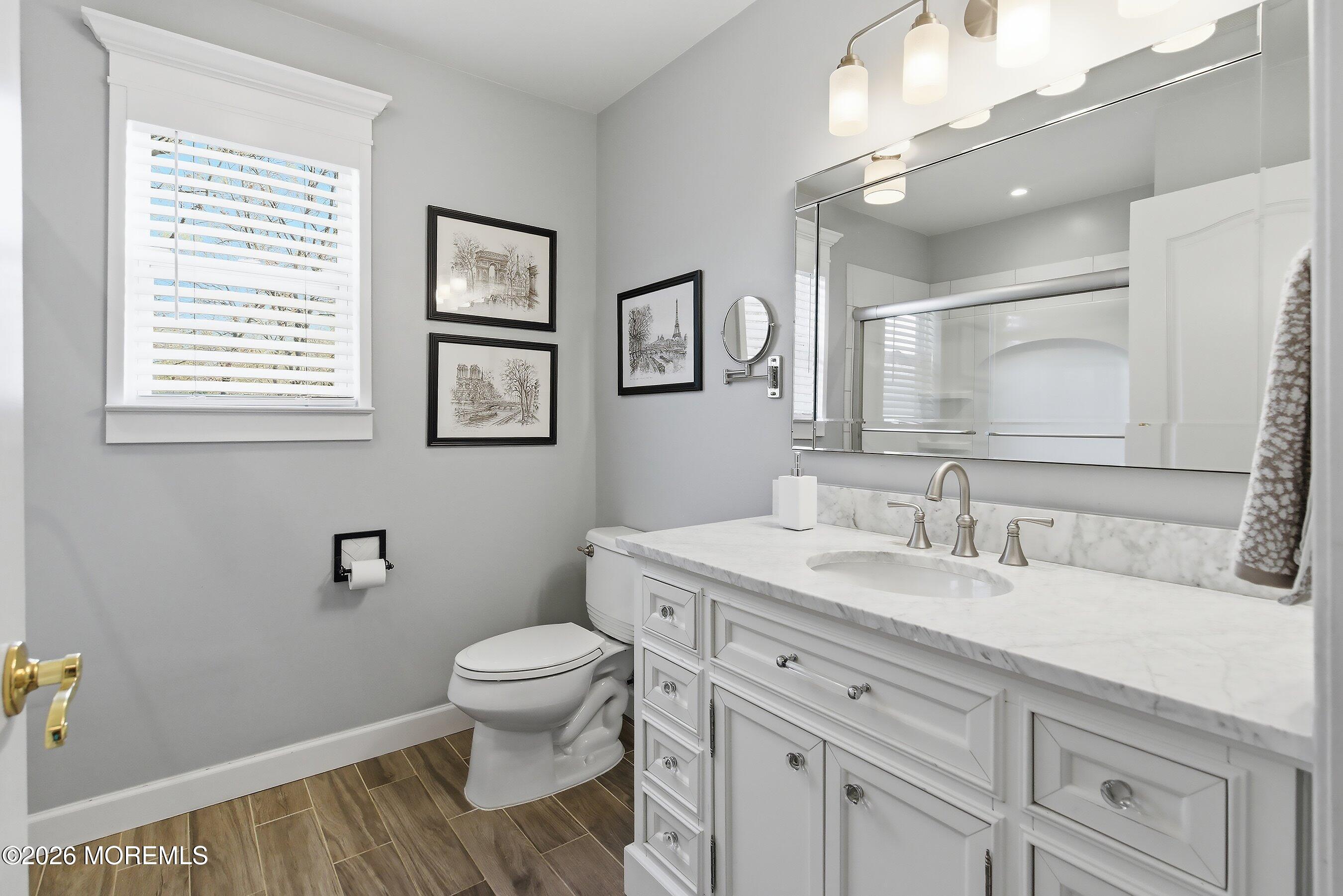 23 Paulette Lane Howell, NJ 07731 - Photo 29 of 35 a bathroom with a granite countertop toilet sink and a mirror