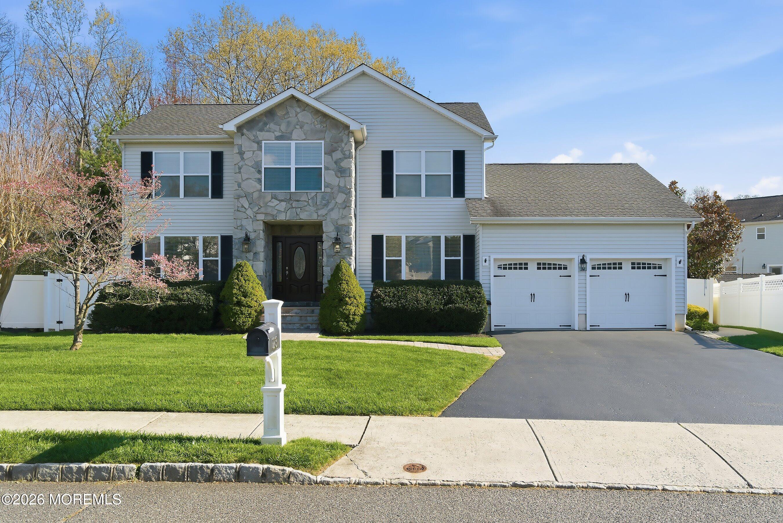 23 Paulette Lane Howell, NJ 07731 - Photo 35 of 35 a front view of a house with a yard and garage
