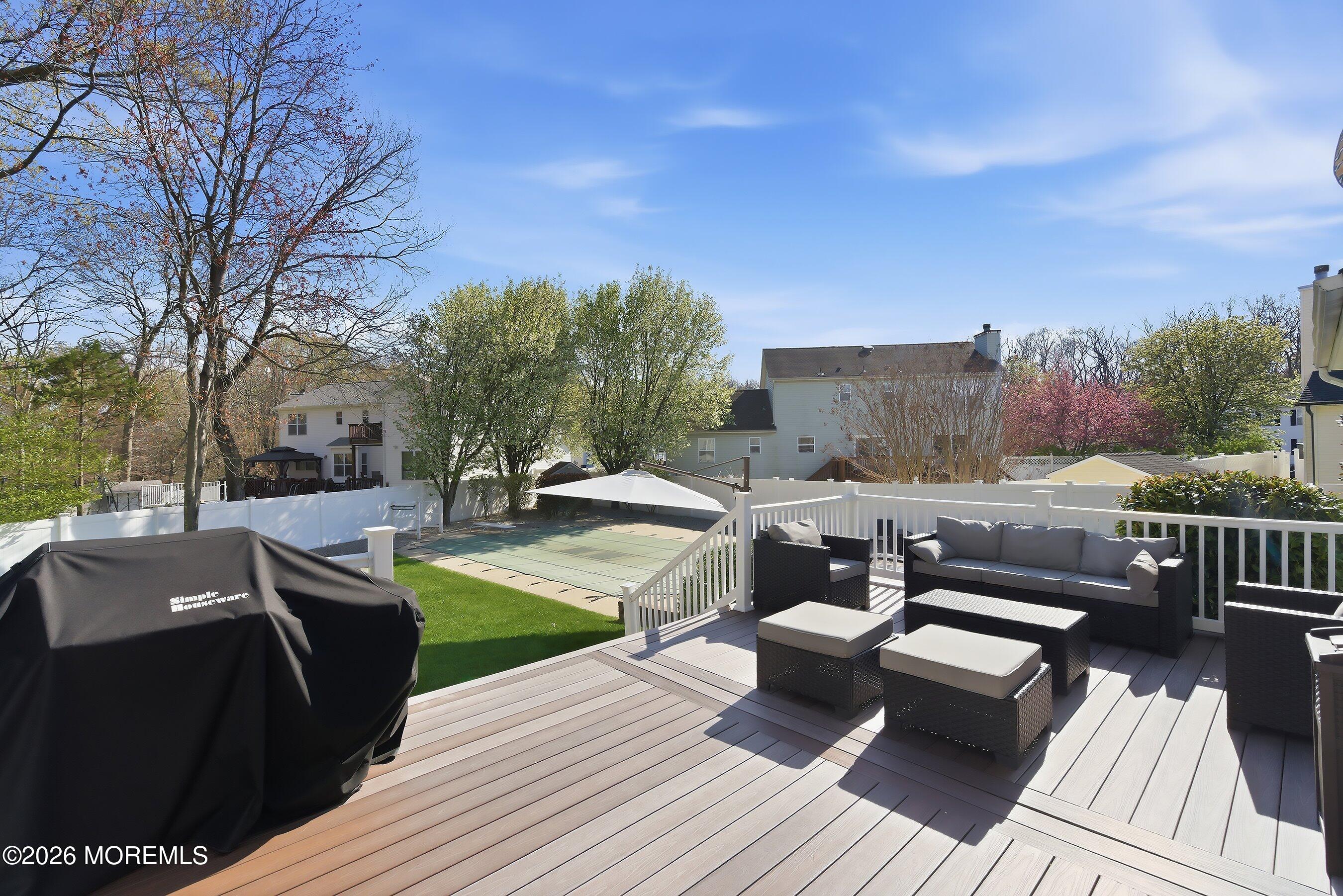 23 Paulette Lane Howell, NJ 07731 - Photo 8 of 35 a view of a roof deck with couches and sky view