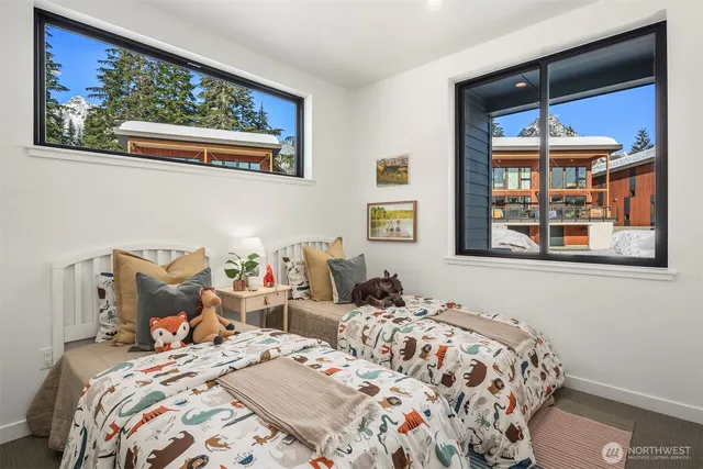 a bedroom with bed and wooden floor