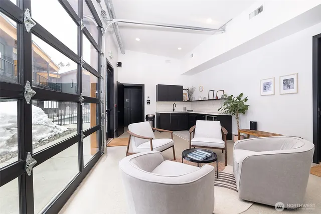 a dining room with furniture and a floor to ceiling window