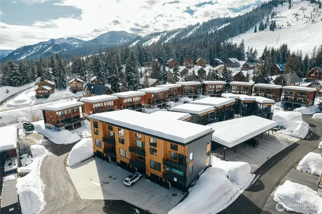 a view of a balcony with couches and a potted plant on a table