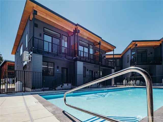 a view of house with a large windows and a small yard