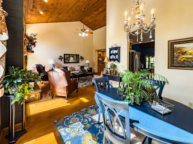 a living room with furniture a fireplace and a table