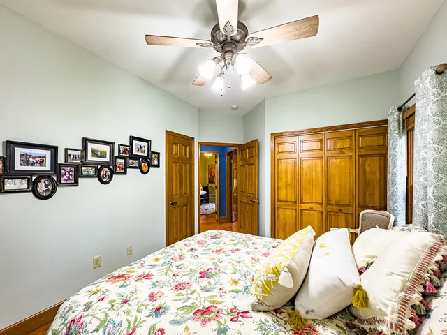 a front view of a house with a yard and trees