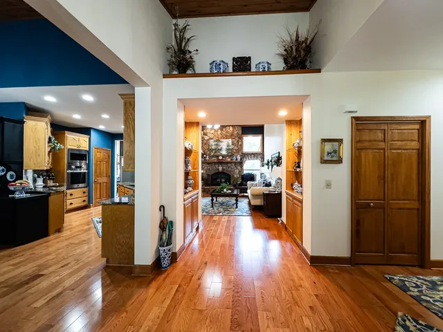 a view of a living room and kitchen with furniture wooden floor