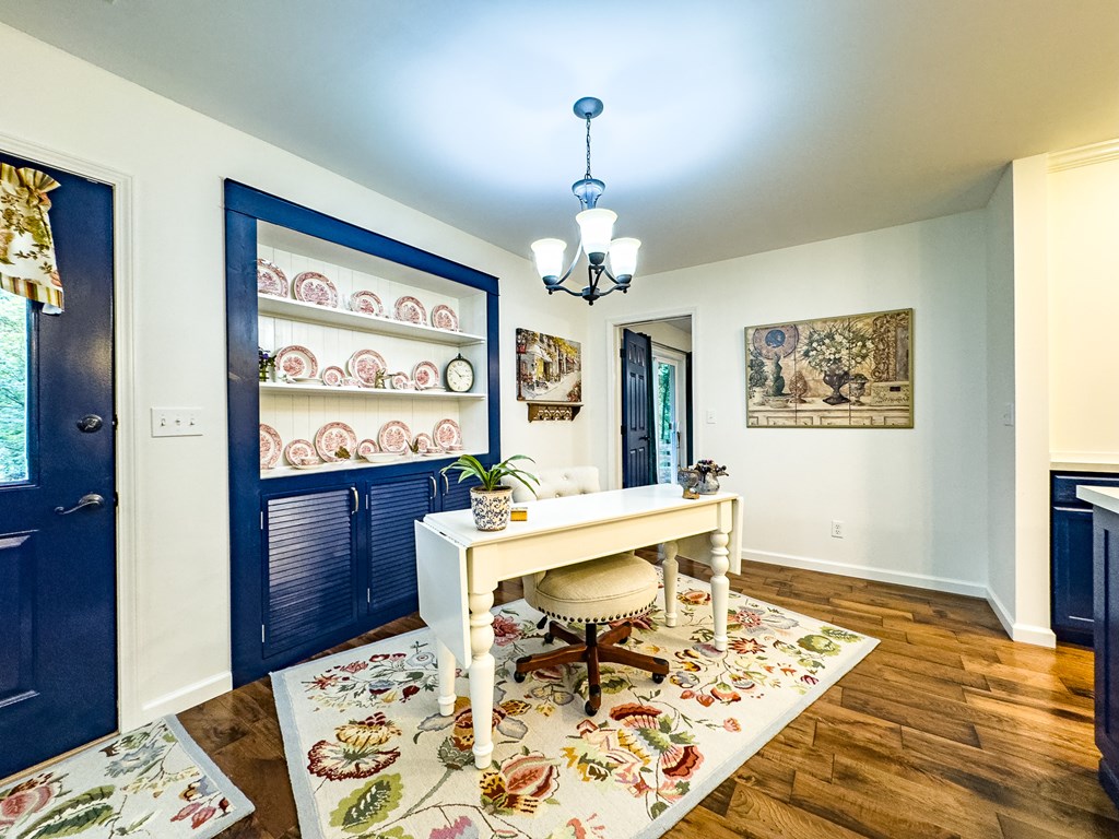 59 Cabin Run Lane Murphy, NC 28906 - Photo 56 of 82 a living room with dining table and paintings on the wall with wooden floor