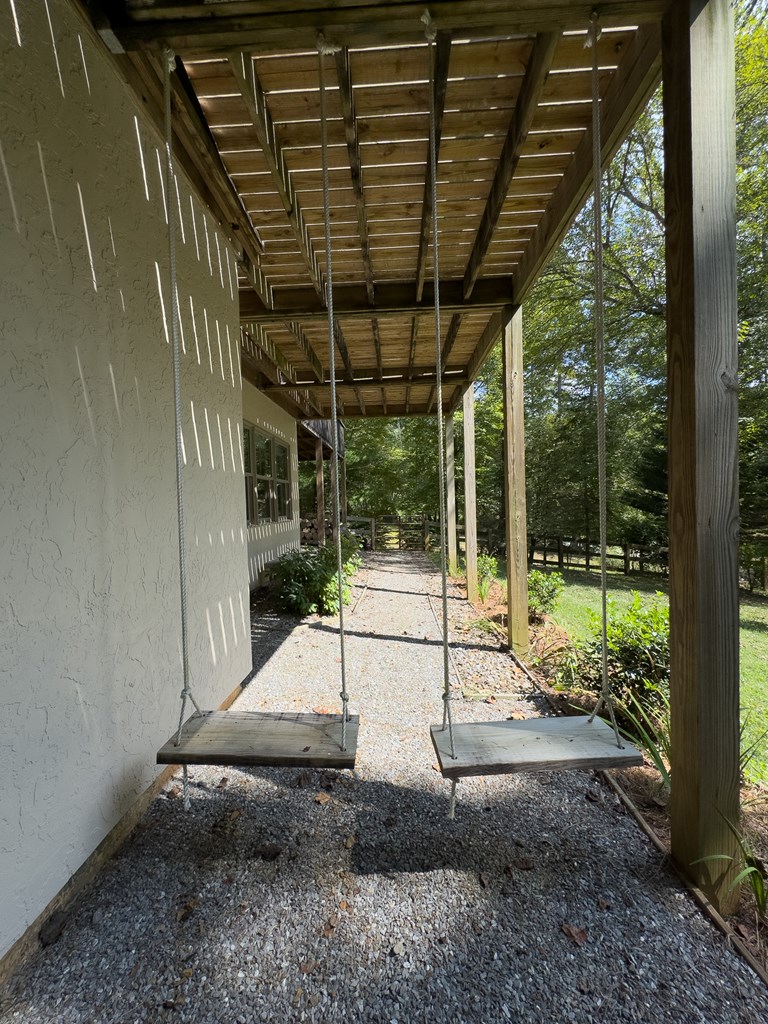 59 Cabin Run Lane Murphy, NC 28906 - Photo 72 of 82 a view of a patio with table and chairs potted plants with floor to ceiling window