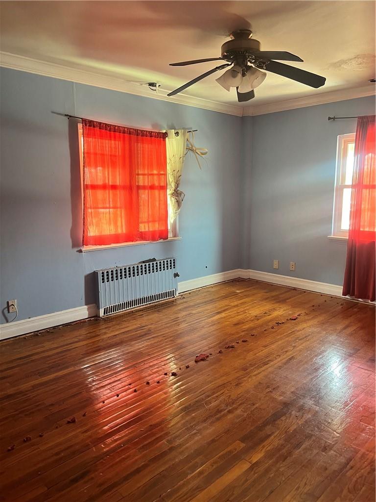2950 Dewitt Place Bronx, NY 10469 - Photo 3 of 8 a view of an empty room with window and wooden floor