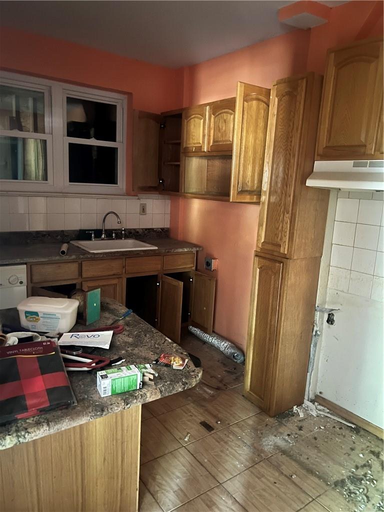 2950 Dewitt Place Bronx, NY 10469 - Photo 5 of 8 a kitchen with granite countertop a refrigerator stove and microwave