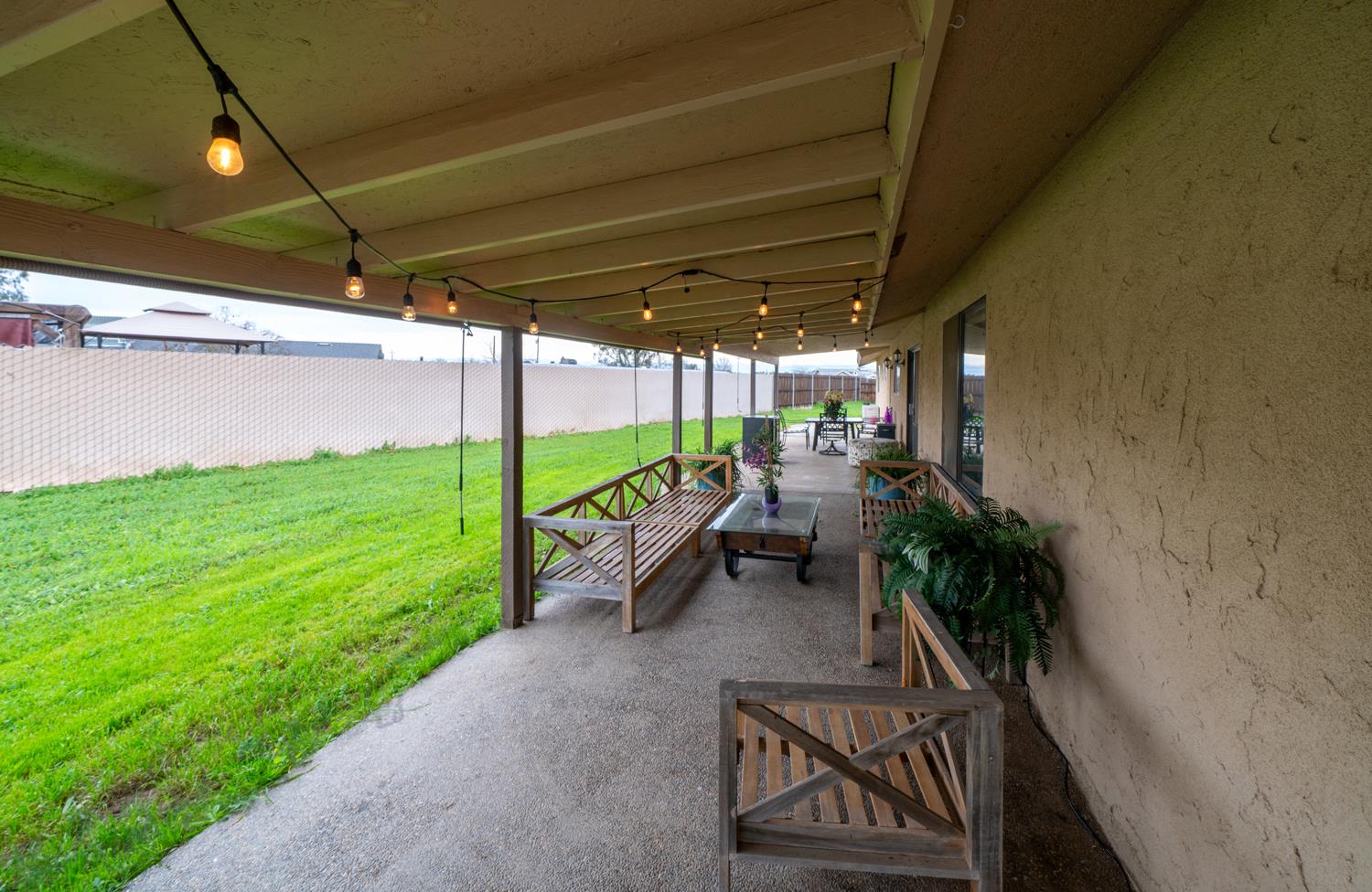 16026 Karen Road Madera, CA 93636 - Photo 13 of 38 a view of a backyard with plants and a patio