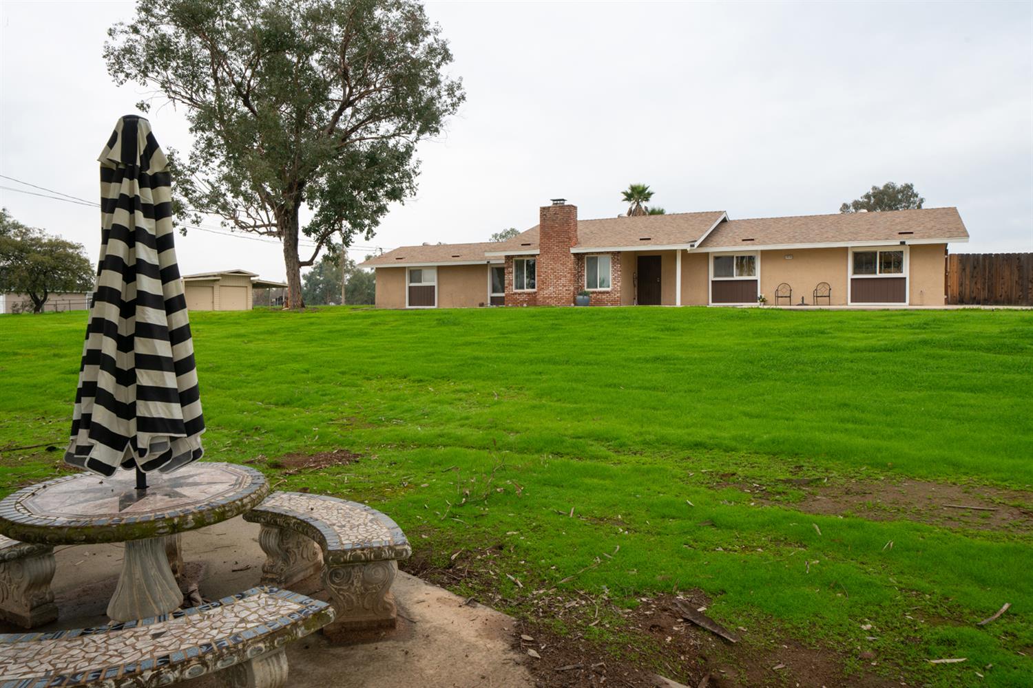 16026 Karen Road Madera, CA 93636 - Photo 10 of 38 a front view of a house with a garden