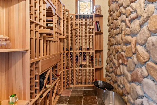 a bedroom with a bed and a large window with the outer view