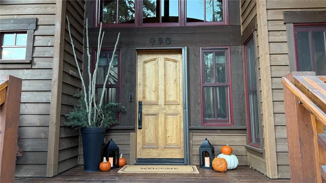 a view of a hallway with a dining table and a chandelier