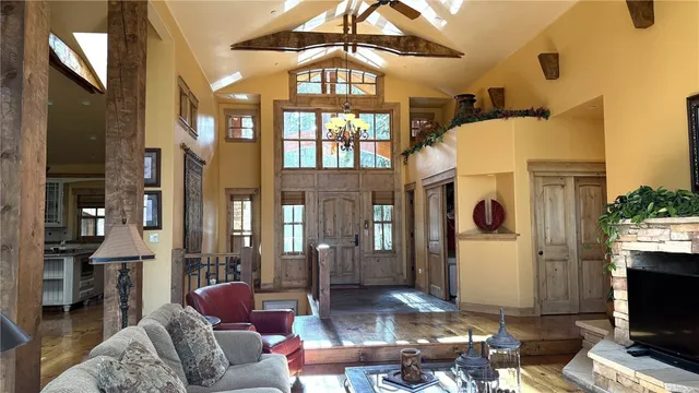 a living room with furniture fireplace and a large window