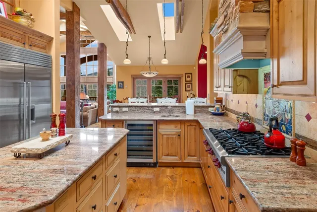 a kitchen with granite countertop a sink stove and cabinets