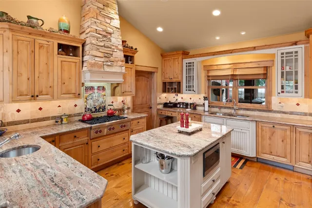 a view of a house with a yard from a lake view