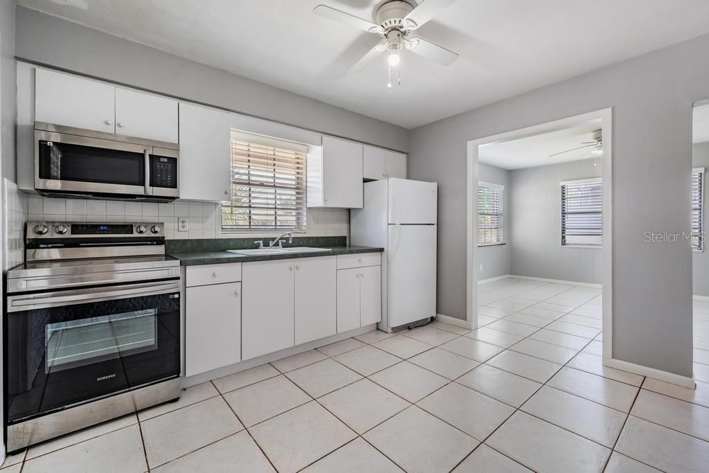 2709 West Abdella Street Tampa, FL 33607 - Photo 12 of 29 a kitchen with stainless steel appliances a stove microwave and refrigerator