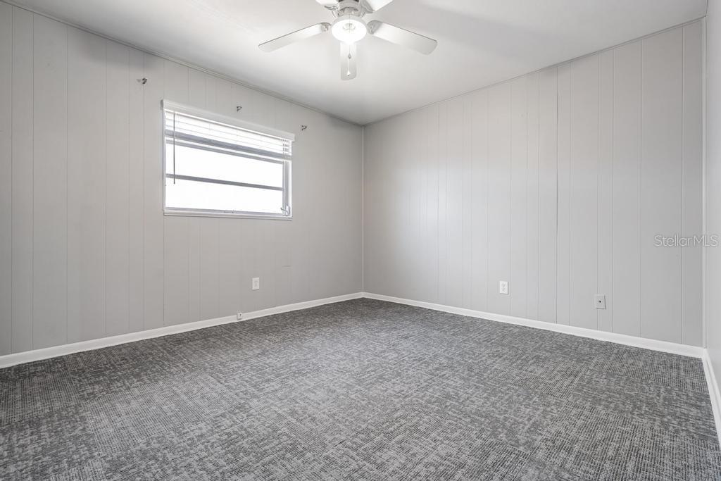 2709 West Abdella Street Tampa, FL 33607 - Photo 18 of 29 an empty room with a chandelier fan and windows