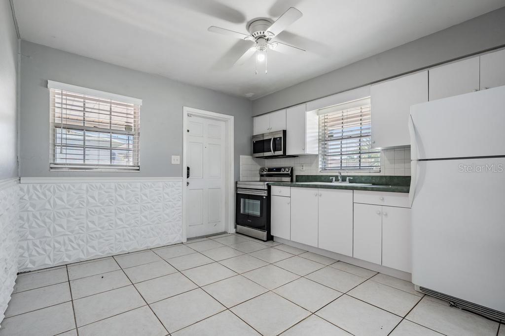 2709 West Abdella Street Tampa, FL 33607 - Photo 10 of 29 a kitchen with white cabinets and white appliances