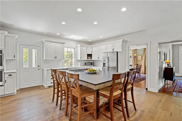 a kitchen with stainless steel appliances kitchen island granite countertop a sink and cabinets