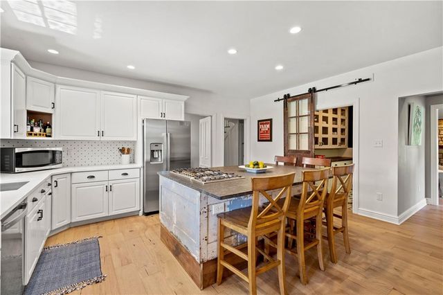 a kitchen with stainless steel appliances granite countertop a stove and cabinets