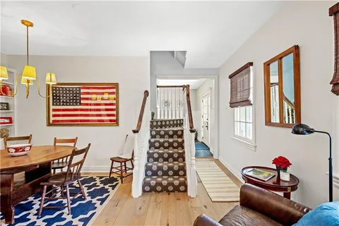 a dining room with furniture and wooden floor