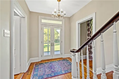 a view of entryway and hall with wooden floor