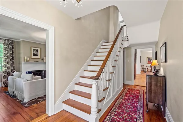 a living room with furniture a rug and a chandelier