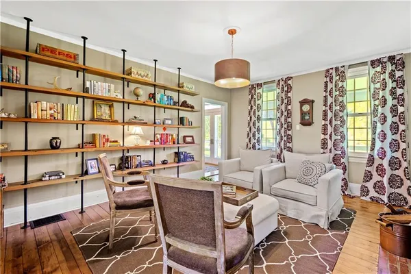 a living room with furniture a fireplace and a chandelier