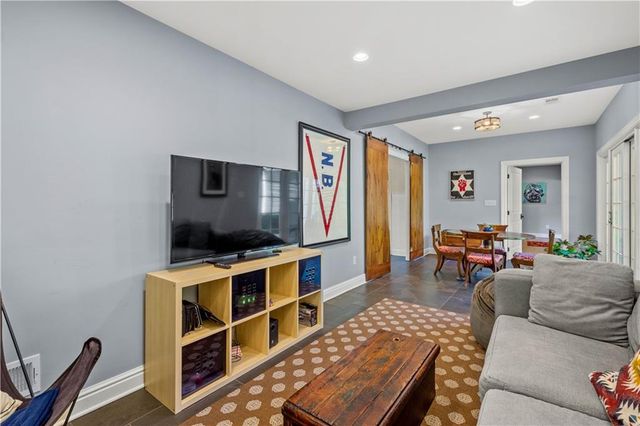 a spacious bedroom with a bed and lamp