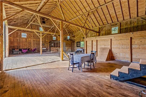 a view of house with backyard and a tree