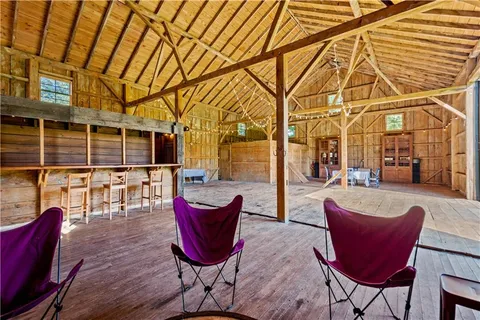 an aerial view of a house with outdoor space swimming pool and tennis court