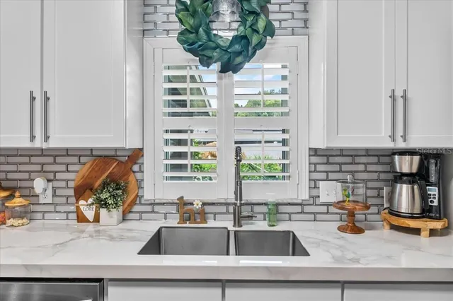 a kitchen with a stove a sink and a refrigerator