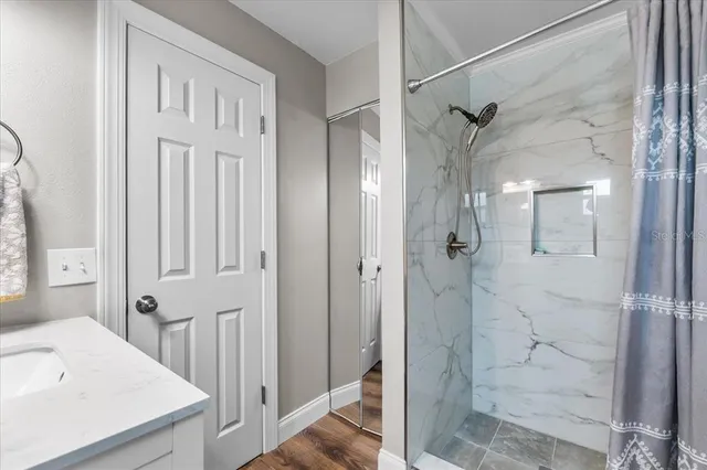 a bedroom with furniture and a flat screen tv