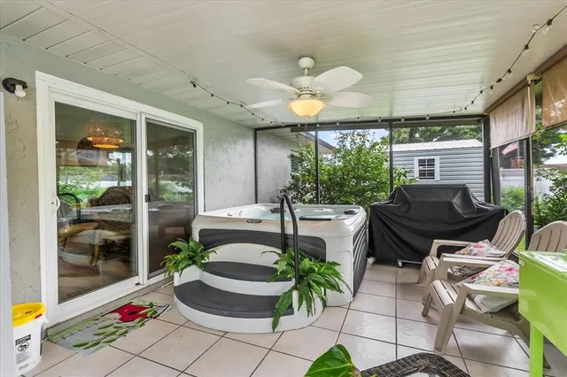 a view of a chair and table in backyard of the house