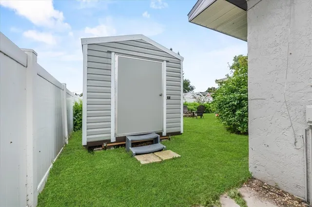 a view of a house with backyard and sitting area