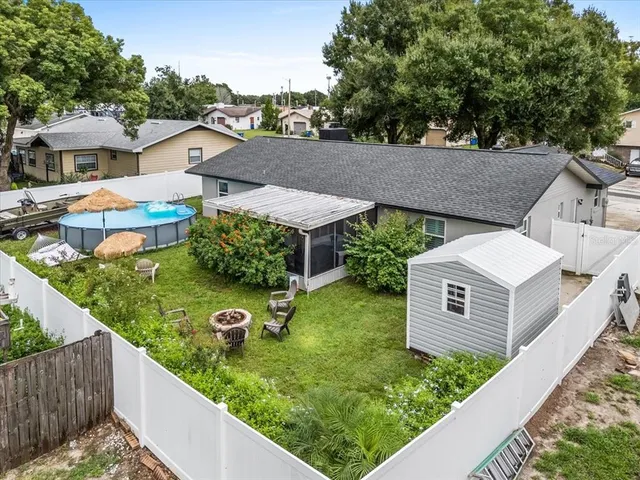an aerial view of a residential houses with outdoor space