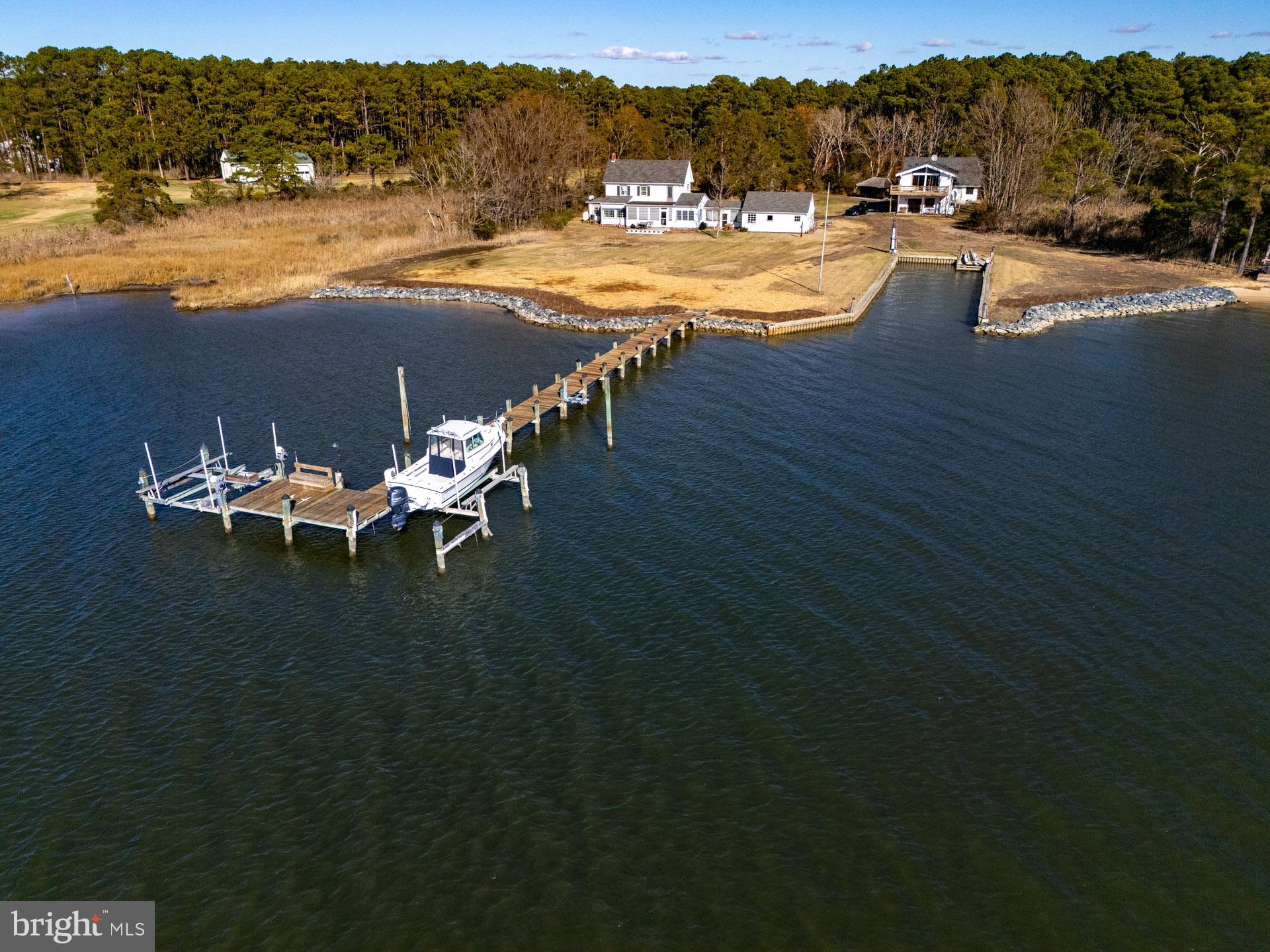 a view of a lake with lawn chairs