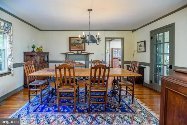 a living room filled with furniture hardwood floor and a large window