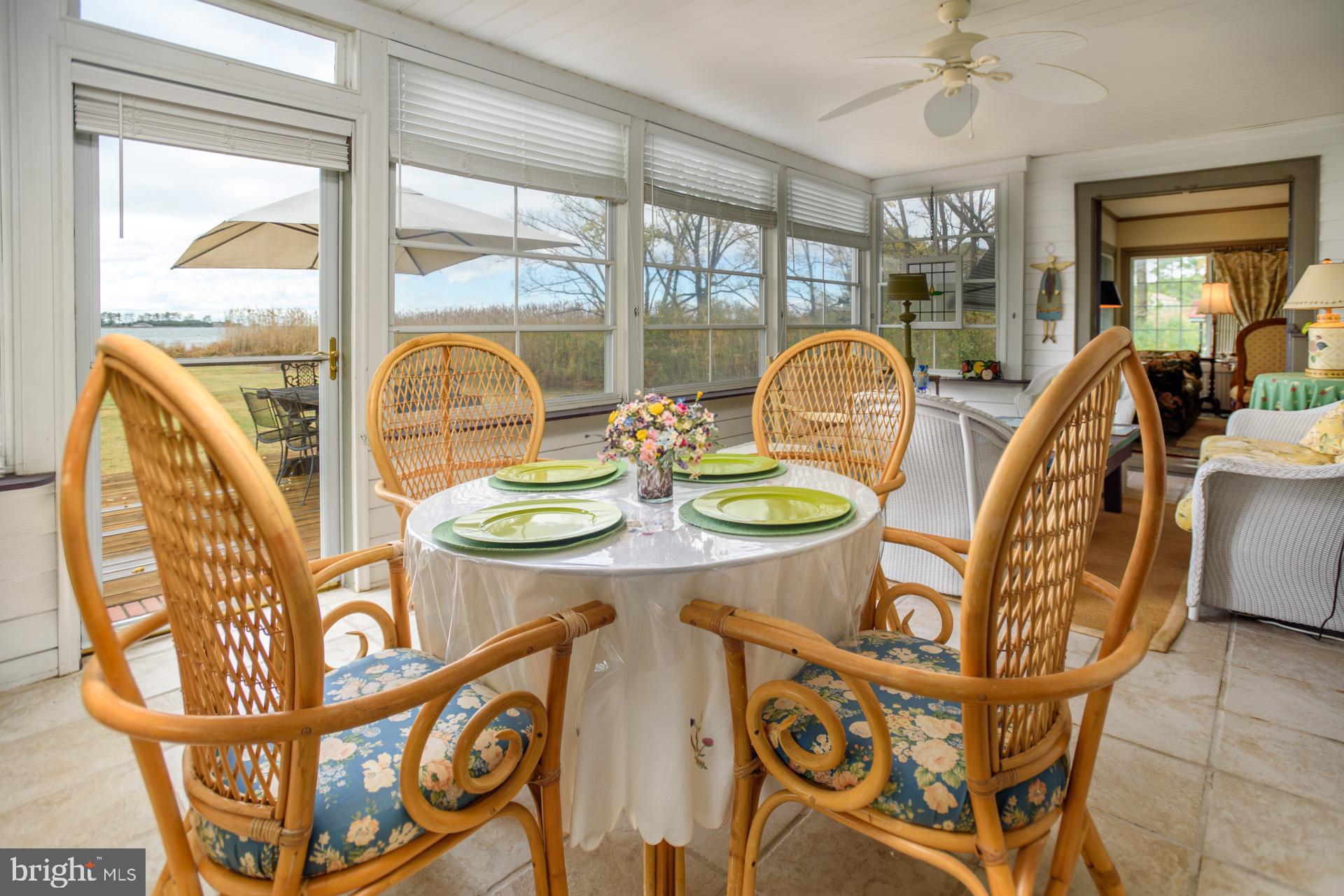 1308 Town Point Road Cambridge, MD 21613 - Photo 22 of 61 a view of a dining room with furniture wooden floor and a chandelier