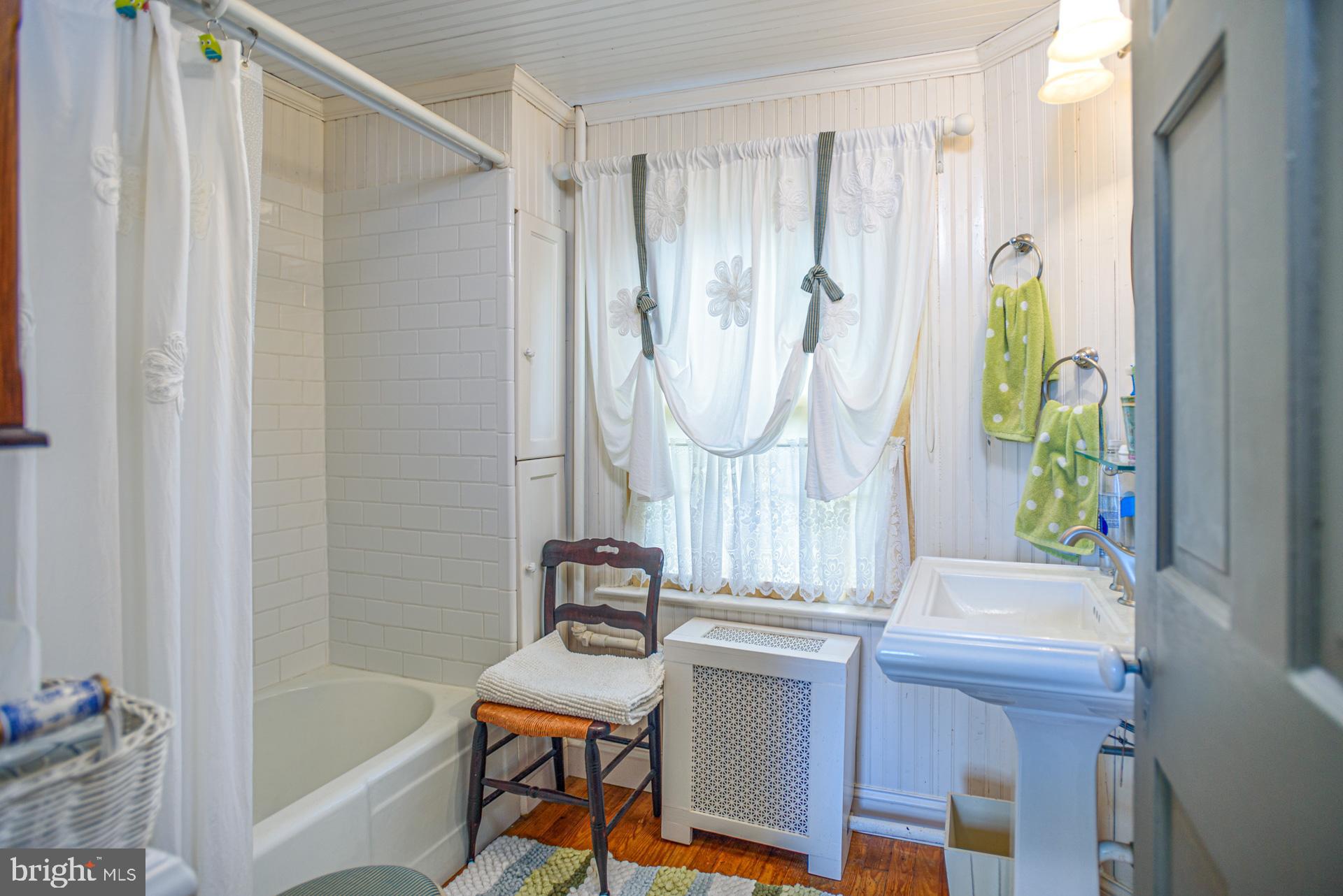 1308 Town Point Road Cambridge, MD 21613 - Photo 29 of 61 a bathroom with a sink a bathtub and a window
