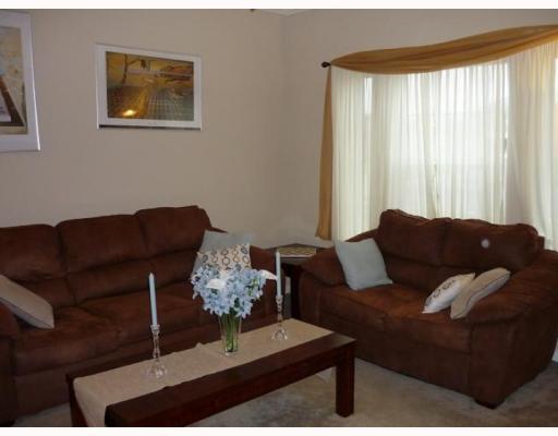 1034 Livermore Street Portland, TX 78374 - Photo 2 of 5 a living room with furniture and a large window