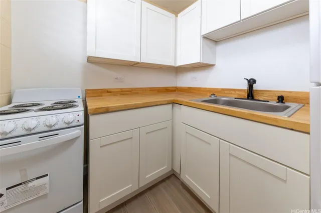 a kitchen with appliances cabinets and a sink