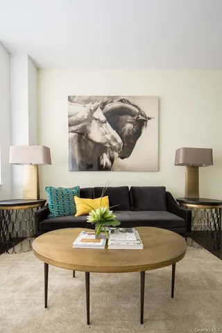 a living room with furniture and a lamp