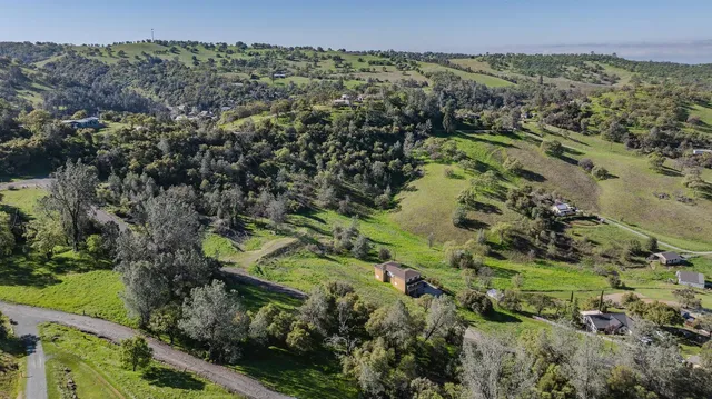 an aerial view of a houses with a yard