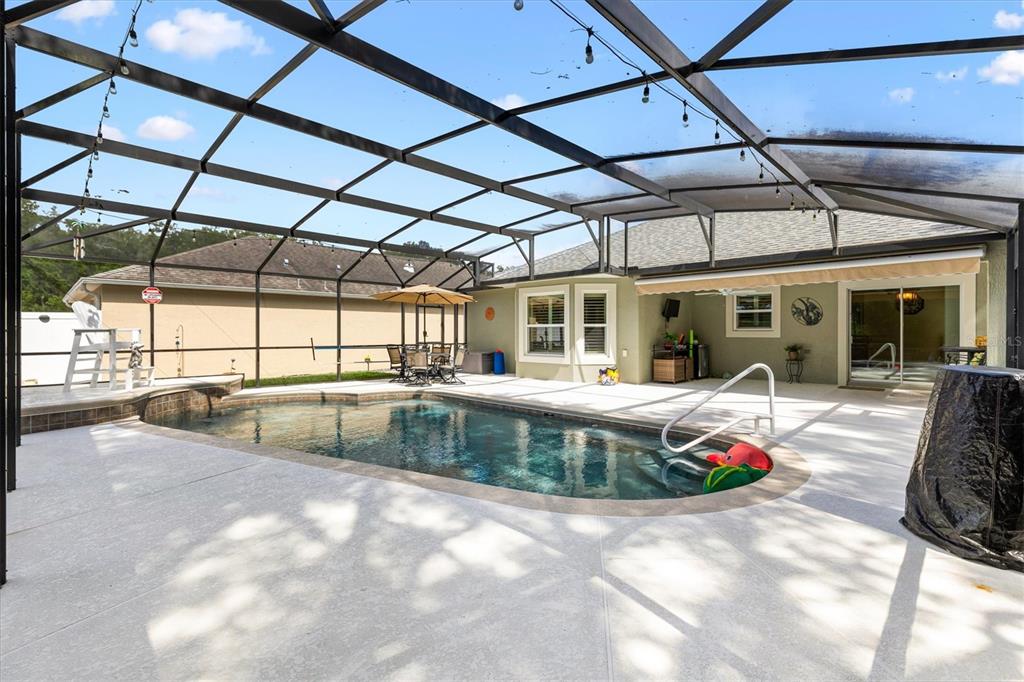 7351 Southeast 169th Cote Loop The Villages, FL 32162 - Photo 28 of 32 a view of a swimming pool with a patio