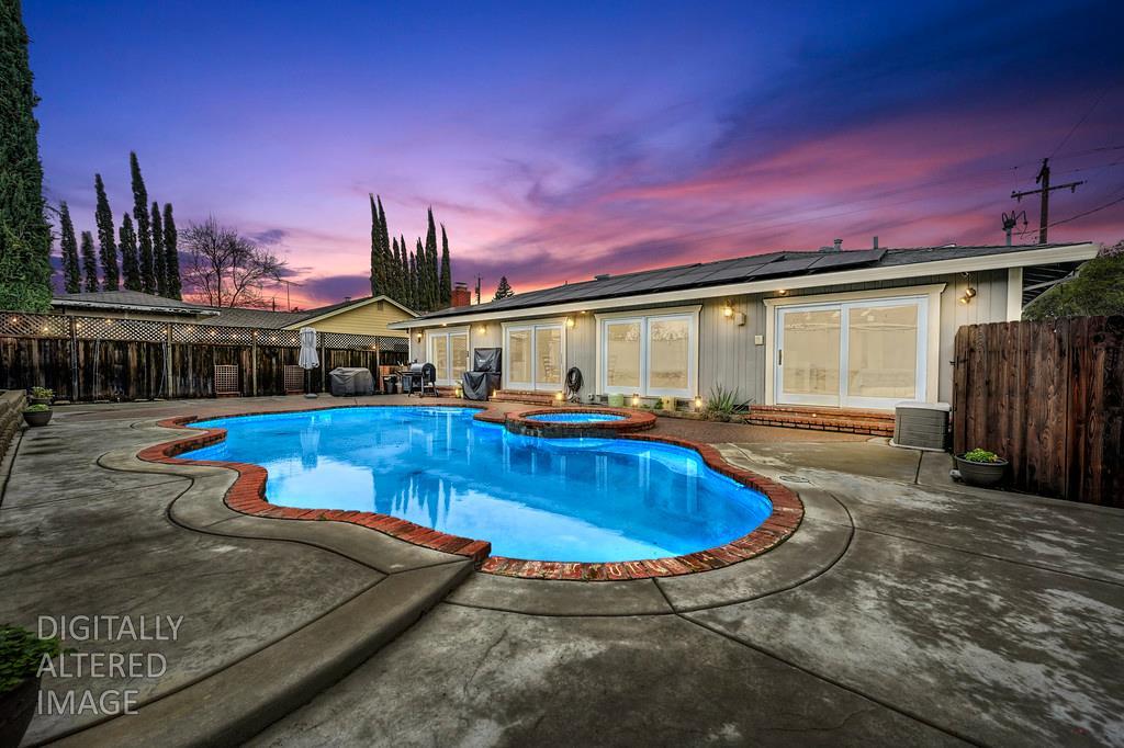 a view of a swimming pool with an outdoor seating